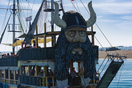 Alanya, Turkey - October 05, 2018. A small sailing ship in a pirate style runs along the coast against a blue sky. Photos of the ship from the sea. The concept of summer holidays, sports, tourismのeditorial素材
