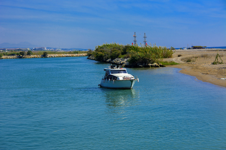 White speedboat on the background of the coast and blue sky. Photos of the ship from the sea. The concept of summer holidays, sports, tourismの写真素材