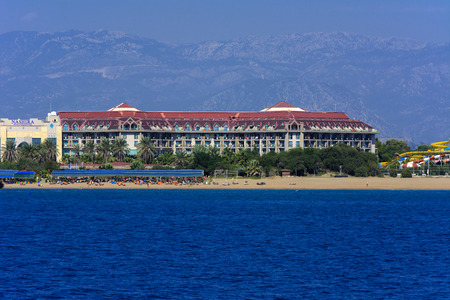 Alanya, Turkey - October 05, 2018. Beautiful hotels of Turkey against the background of distant mountains and blue sky. Photos of coast from the sea. The concept of summer holidays, sports, tourismのeditorial素材