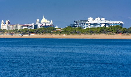 Alanya, Turkey - October 05, 2018. Beautiful hotels of Turkey against the background of distant mountains and blue sky. Photos of coast from the sea. The concept of summer holidays, sports, tourismのeditorial素材