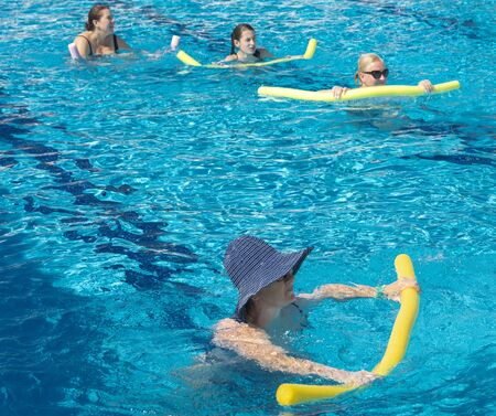 Alanya, Turkey - October 05, 2018. A group of people is engaged in aqua aerobics in the blue clear water of the pool at Kirman Sidera Luxury Spa. Fitness concept, summer vacation, sport, tourismのeditorial素材