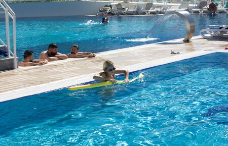 Alanya, Turkey - October 05, 2018. A group of people is engaged in aqua aerobics in the blue clear water of the pool at Kirman Sidera Luxury Spa. Fitness concept, summer vacation, sport, tourismのeditorial素材