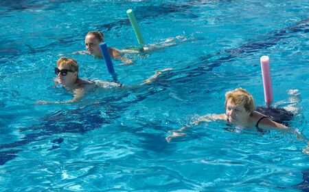 Alanya, Turkey - October 05, 2018. A group of people is engaged in aqua aerobics in the blue clear water of the pool at Kirman Sidera Luxury Spa. Fitness concept, summer vacation, sport, tourismのeditorial素材