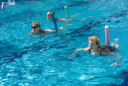 Alanya, Turkey - October 05, 2018. A group of people is engaged in aqua aerobics in the blue clear water of the pool at Kirman Sidera Luxury Spa. Fitness concept, summer vacation, sport, tourismのeditorial素材