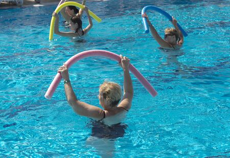 Alanya, Turkey - October 05, 2018. A group of people is engaged in aqua aerobics in the blue clear water of the pool at Kirman Sidera Luxury Spa. Fitness concept, summer vacation, sport, tourismのeditorial素材