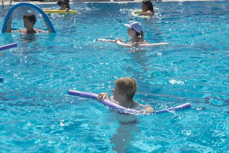 Alanya, Turkey - October 05, 2018. A group of people is engaged in aqua aerobics in the blue clear water of the pool at Kirman Sidera Luxury Spa. Fitness concept, summer vacation, sport, tourismのeditorial素材