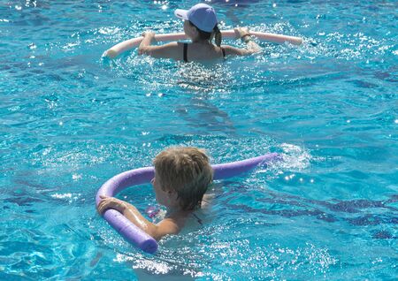 Alanya, Turkey - October 05, 2018. A group of people is engaged in aqua aerobics in the blue clear water of the pool at Kirman Sidera Luxury Spa. Fitness concept, summer vacation, sport, tourismのeditorial素材