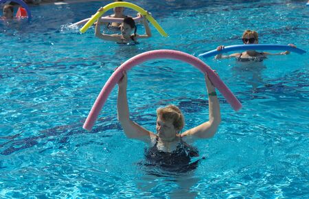 Alanya, Turkey - October 05, 2018. A group of people is engaged in aqua aerobics in the blue clear water of the pool at Kirman Sidera Luxury Spa. Fitness concept, summer vacation, sport, tourismのeditorial素材