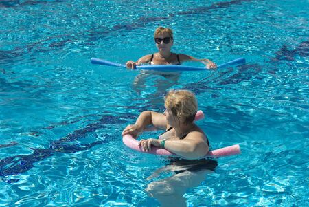 Alanya, Turkey - October 05, 2018. A group of people is engaged in aqua aerobics in the blue clear water of the pool at Kirman Sidera Luxury Spa. Fitness concept, summer vacation, sport, tourismのeditorial素材
