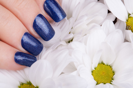 Beautiful nails and blue flower.の写真素材