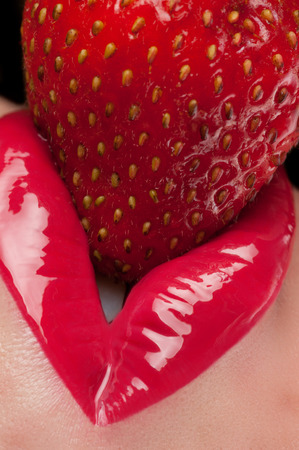 Lips with red glitter and strawberries.の写真素材