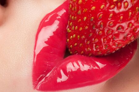 Lips with red glitter and strawberries.の写真素材