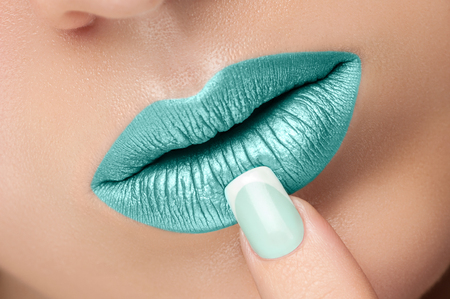 Turquoise lip gloss and a beautiful nails.の写真素材
