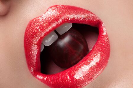 Lip gloss with red berriesの写真素材