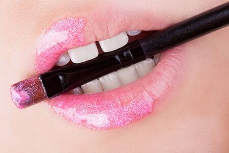Pink glitter on natural lips. Close-up . Great idea for advertising lip gloss.の写真素材