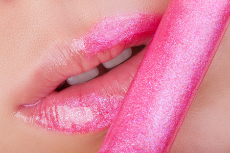 Pink glitter on natural lips. Close-up . Great idea for advertising lip gloss.の写真素材