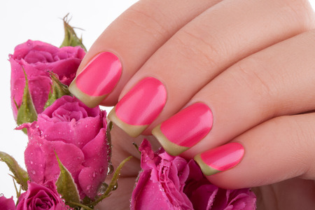 Beautiful pink nails on a white background with flowers.の写真素材