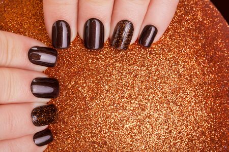 Beautiful brown nails and Christmas toy.の写真素材