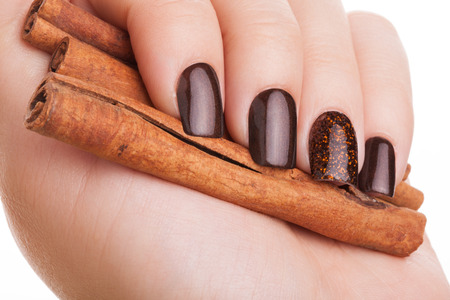 Beautiful brown nails close up and cinnamon.の写真素材