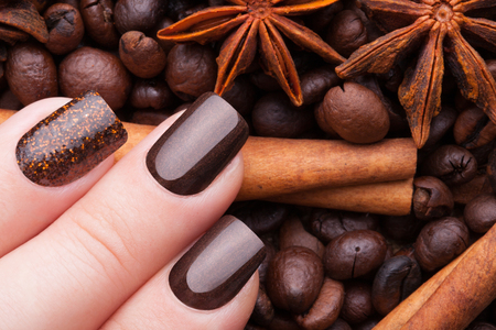 Beautiful brown nails close-up and coffee.の写真素材