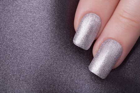 Very beautiful silver metallic nails closeup.の写真素材