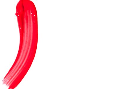Red lip gloss on a white background close-up.の写真素材