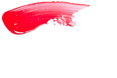 Red lip gloss on a white background close-up.の写真素材