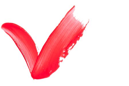 Red lip gloss on a white background close-up.の写真素材