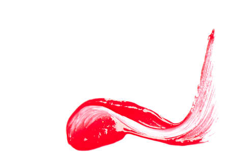 Red lip gloss on a white background close-up.の写真素材