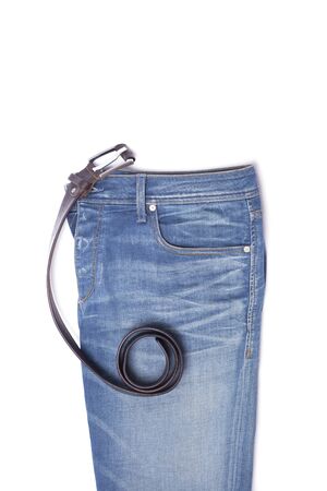 Blue jeans with a male belt lie on a white backgroundの写真素材