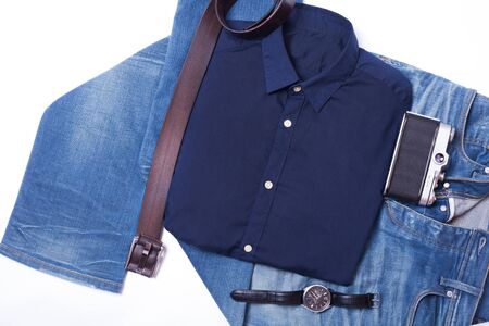 Blue jeans with a male belt lie on a white backgroundの写真素材