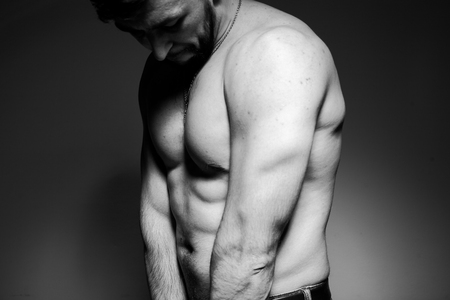 Black and white photo of a handsome and sporty guy close-up in studioの写真素材