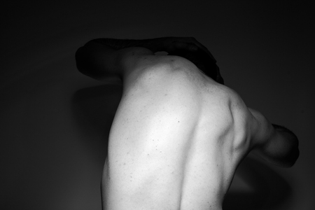 Black and white photo of a handsome and sporty guy close-up in studioの写真素材