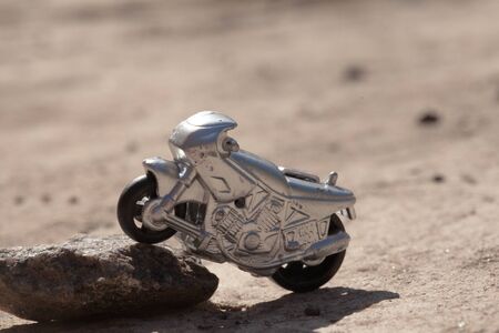 Small toy gray sport bike on nature close-up