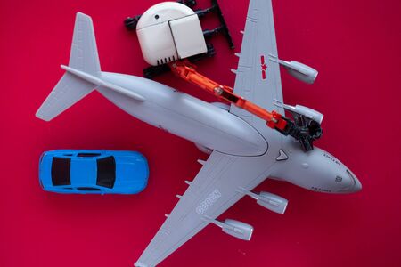 Photo of a toy car on a red background close-up.