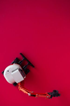 Photo of a toy car on a red background close-up.の写真素材