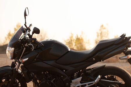 One black motorcycle in the desert in autumn time.の写真素材