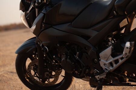 One black motorcycle in the desert in autumn time.の写真素材