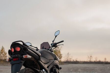 One black motorcycle in the desert in autumn time.の写真素材