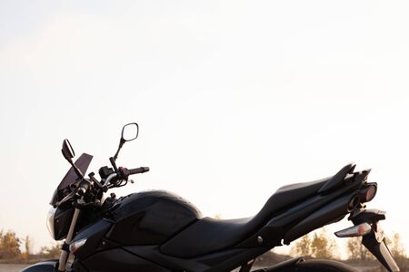 One black motorcycle in the desert in the fall.の写真素材