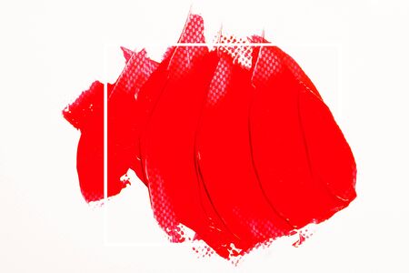 The texture of red lipstick on a white background, close-up.の写真素材
