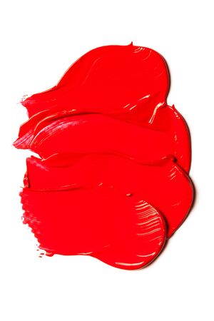 Texture of classic red lipstick on a white background close-up.の写真素材