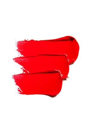 Texture of classic red lipstick on a white background close-up.の写真素材