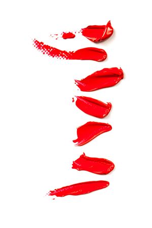 Texture of classic red lipstick on a white background close-up.の写真素材