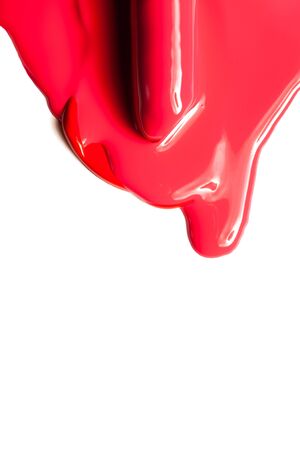 Texture of classic red lipstick on a white background close-up.の写真素材