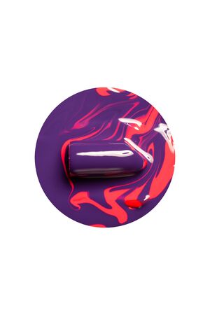 Violet lipstick in red paint on a white background.の写真素材