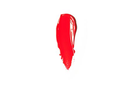 Texture of classic red lipstick on a white background close-up.の写真素材