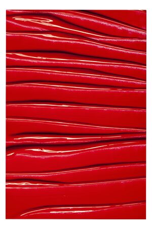 Texture of classic red lipstick on a white background close-up.の写真素材