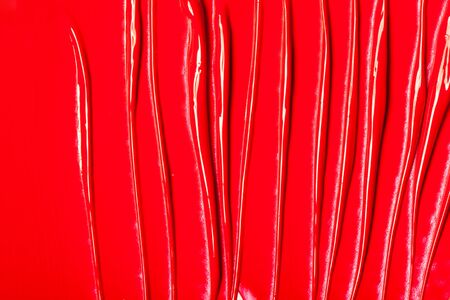 Texture of classic red lipstick on a white background close-up.の写真素材