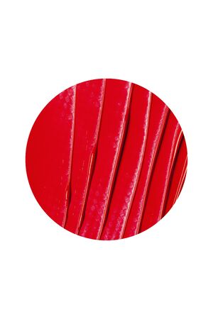 Texture of classic red lipstick on a white background close-up.の写真素材